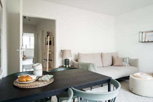 a living room with a table and a couch at Fischtown Apartment II in Bremerhaven