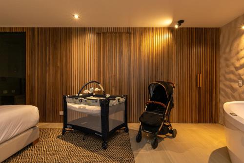 a bathroom with a bath tub and a baby stroller at Landmark Hotel in Medellín