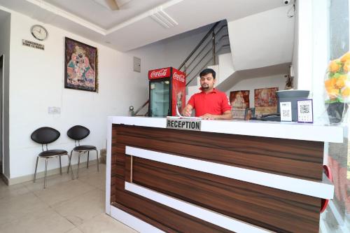 a man standing behind a counter at a store at Four Seasons in Sikandra