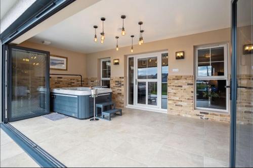 a large room with a bath tub in the middle at Little Gleddoch in Dumbarton