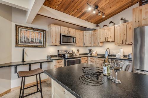 a kitchen with wooden cabinets and a black counter top at Laurelwood Condominiums 309 in Snowmass Village