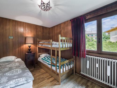 une chambre avec deux lits superposés et une fenêtre dans l'établissement Appartement Confort 2 Chambres, Cheminée, Balcon, Garage - Megève Rochebrune - FR-1-453-195, à Megève