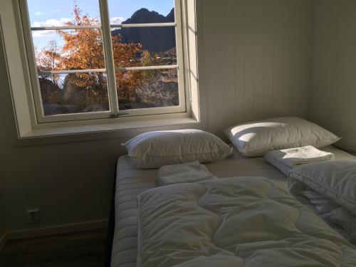 a bedroom with two beds and a window at Lofoten Sea Lodge in Sennesvik