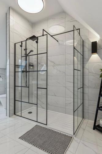 a shower with glass doors in a bathroom at Little Gleddoch in Dumbarton