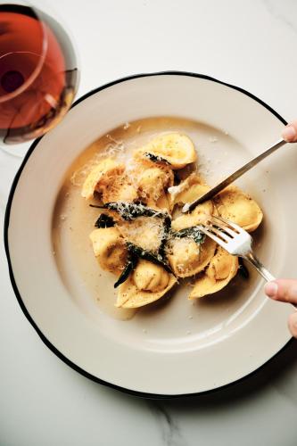 a person holding a fork and a plate of food at Hotel Grand Stark in Portland