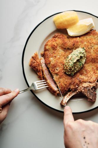 a person eating a plate of pancakes with a fork at Hotel Grand Stark in Portland