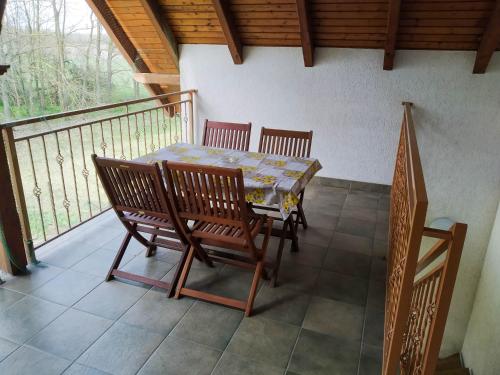 a balcony with a table and chairs on a porch at Bodzás vendégház - Bodza u.4. in Kiskunmajsa