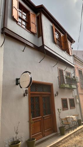 a building with a door and a sign on it at Hanole Guest House in Ayvalık