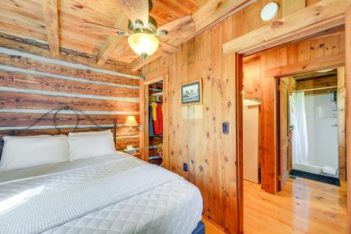 ein Schlafzimmer mit einem Bett in einem Zimmer mit Holzwänden in der Unterkunft Dobson Vacation Rental - Close to Wineries! in Dobson
