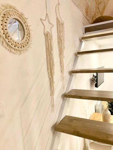 a wall with wooden shelves and a mirror at Stella Marina Luxury in Polignano a Mare