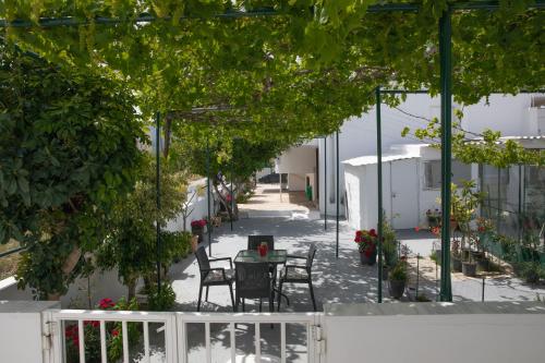 a patio with a table and chairs in a courtyard at Iliana's House in Zipárion