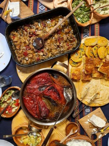 a table full of food with a pan of food at Villa Old House BN in Bitola