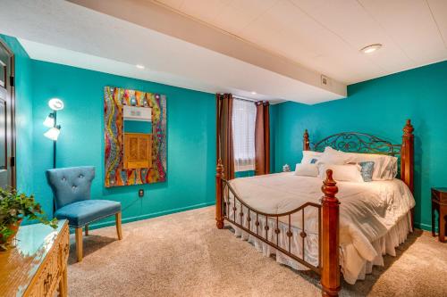 um quarto com paredes azuis e uma cama e uma cadeira em Peaceful Boulder Apartment with Private Patio! em Boulder