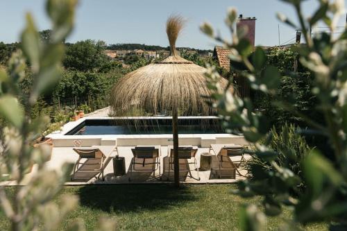 a gazebo with chairs and a pool at Casa da Aldeia - Baleal - Peniche in Casais Brancos