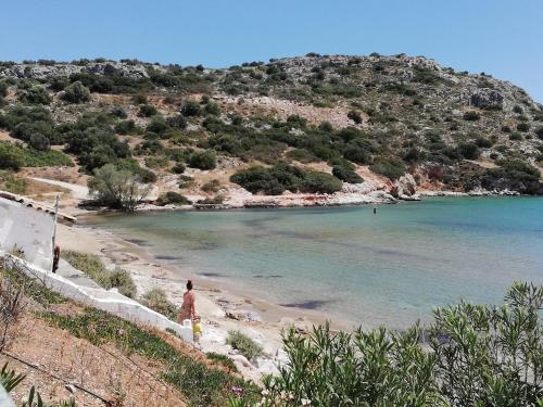 a person standing on a beach near the water at ALTHEA HOLIDAY STUDIO in Aghia Marina