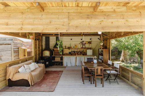 a living room and dining room of a house with a wooden ceiling at Casa da Aldeia - Baleal - Peniche in Casais Brancos