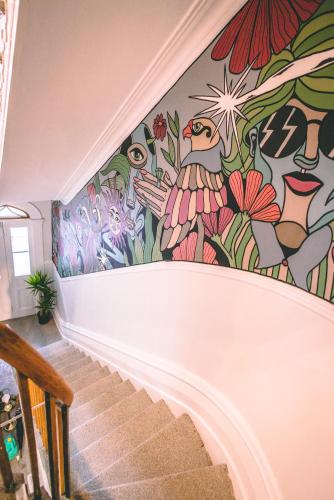 a mural of flowers on the wall of a staircase at Auberge de la Paix in Quebec City