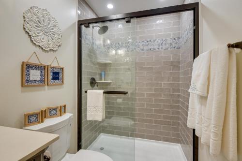 a bathroom with a shower with a glass door at Waterfront Maryland Vacation Home Private Beach! in Ridge