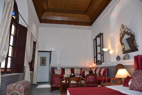 sala de estar con sillas y mesa en una habitación en Dar Al Batoul, en Fez