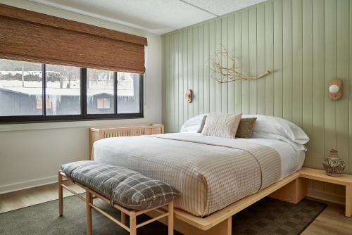 a bedroom with a bed and a window at Bluebird Lake Placid in Lake Placid