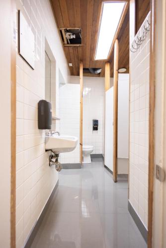a bathroom with a sink and a toilet at Auberge de la Paix in Quebec City