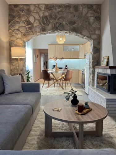 a living room with a couch and a table at Relax house by the sea in Volos