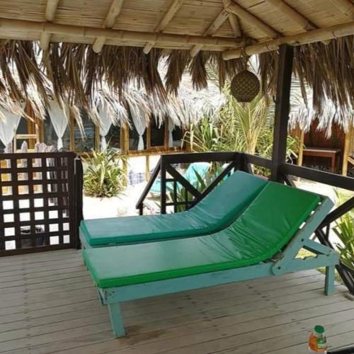 a green hammock on the deck of a resort at Bora Bora Bungalows in Los Órganos