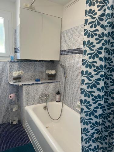 a bathroom with a tub and a white cabinet at villa Siana in Antibes