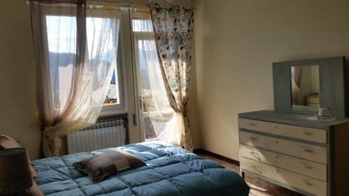1 dormitorio con 1 cama, vestidor y ventana en Apartment Iseo Lake, en Sale Marasino