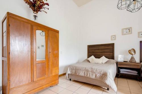 a bedroom with a bed and a wooden door at Casa Praxedis in Santiago