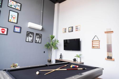 a room with a pool table and a tv at Royal Living Poblado in Medellín