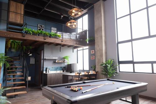 a pool table in a room with a loft at Royal Living Poblado in Medellín