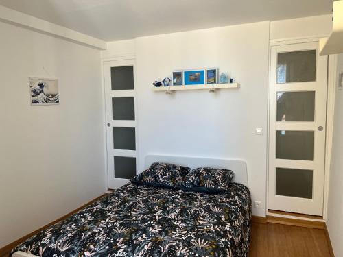 um quarto com uma cama e duas janelas em Appartement Hyères - Centre ville 'Parcours des Arts' 1 chambre 2 personnes - Patricia em Hyères