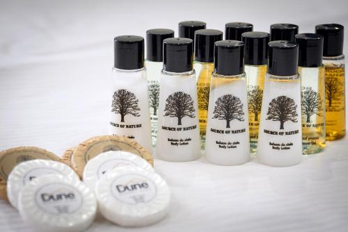 a group of four bottles of oils on a table at Domek nad Morzem Łeba Ruska Bania Sauna Jacuzzi in Łeba