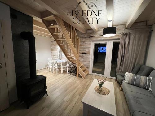 a living room with a couch and a wood stove at oBłędne Chaty in Wünschelburg