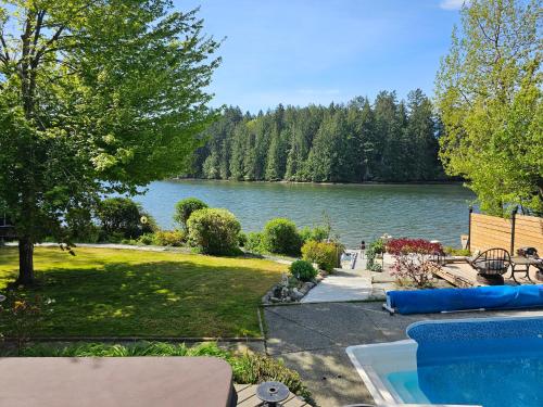 a view of a lake from the backyard of a house at luxury ocean dock pool villa in Ladysmith