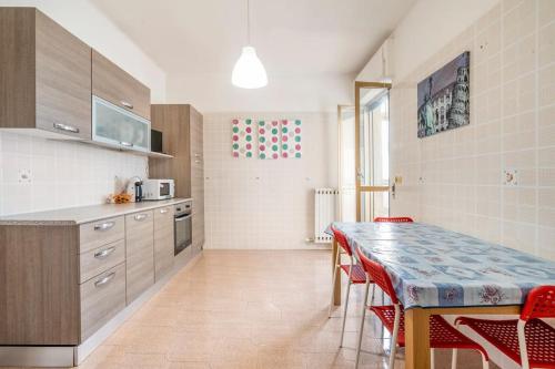 a kitchen with a table and some red chairs at Casa Vacanze Visit Puglia in Casamassima