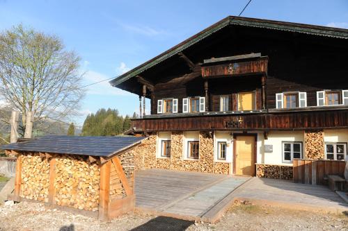 a large wooden house with a lot of fire wood at Ferienhof Holzmeister in Sankt Jakob in Haus
