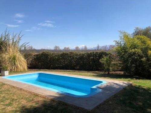 una piscina nel cortile di una casa di Stunning modern apartment in gated community a Ciudad Lujan de Cuyo