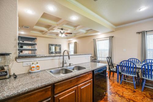 a kitchen with a sink and a table with chairs at San Antonio Townhome about 2 Mi to Aquarium! in San Antonio