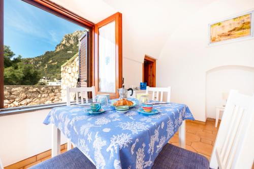 a dining room with a table and a window at Villaggio Residence Nettuno in Massa Lubrense