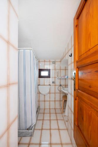 a small bathroom with a sink and a refrigerator at Villaggio Residence Nettuno in Massa Lubrense