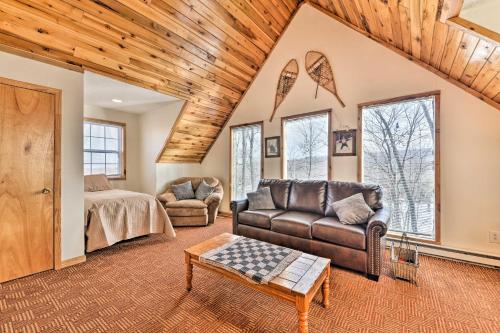 a living room with a couch and a bed and windows at Ski-In and Ski-Out Ghent Cabin with Mountain Views! in Ghent
