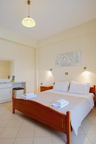 a bedroom with a large bed with white sheets at Garden Villa Landi in Ksamil