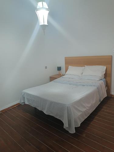 a bedroom with a large bed with a light above it at Céntrico melilla in Melilla