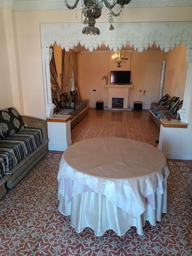 a living room with a table in the middle of a room at Céntrico cardenal cisneros 7 3d sin ascensor in Melilla