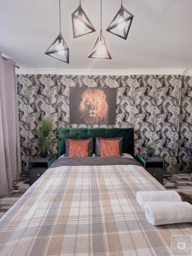 a bedroom with a large bed with a lion on the wall at RentHouse Apartments Urban Lion in Chişinău