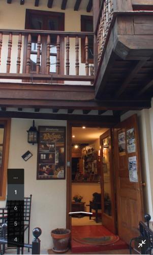 a building with a wooden staircase above a door at Hostería La Antigua in Potes