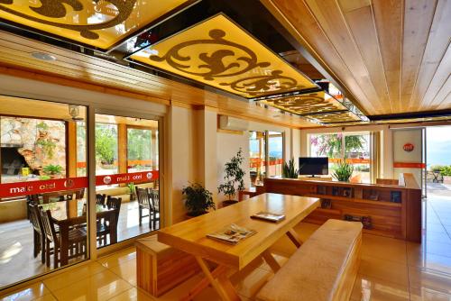 a dining room with a wooden table and chairs at Kas Maki Hotel in Kas