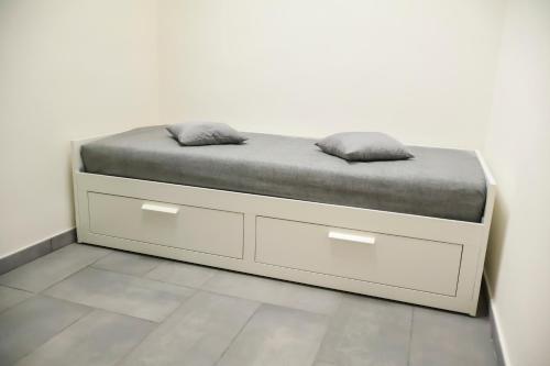 a bed with two pillows on it in a room at Wellness Home Catania in Catania